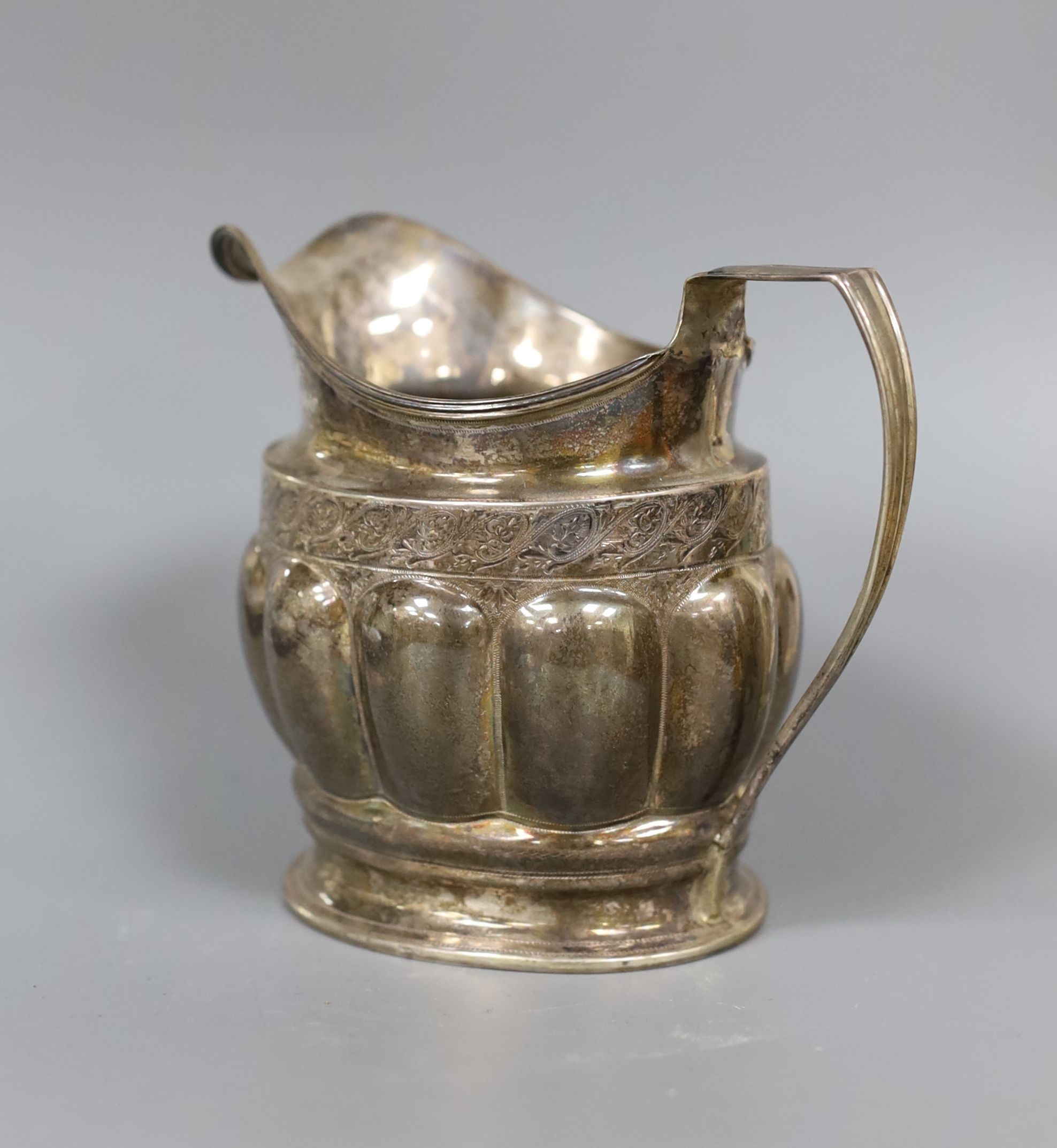 A George III silver cream jug, with lobed body, Soloman Hougham, London, 1799, 10.3cm, 159 grams.